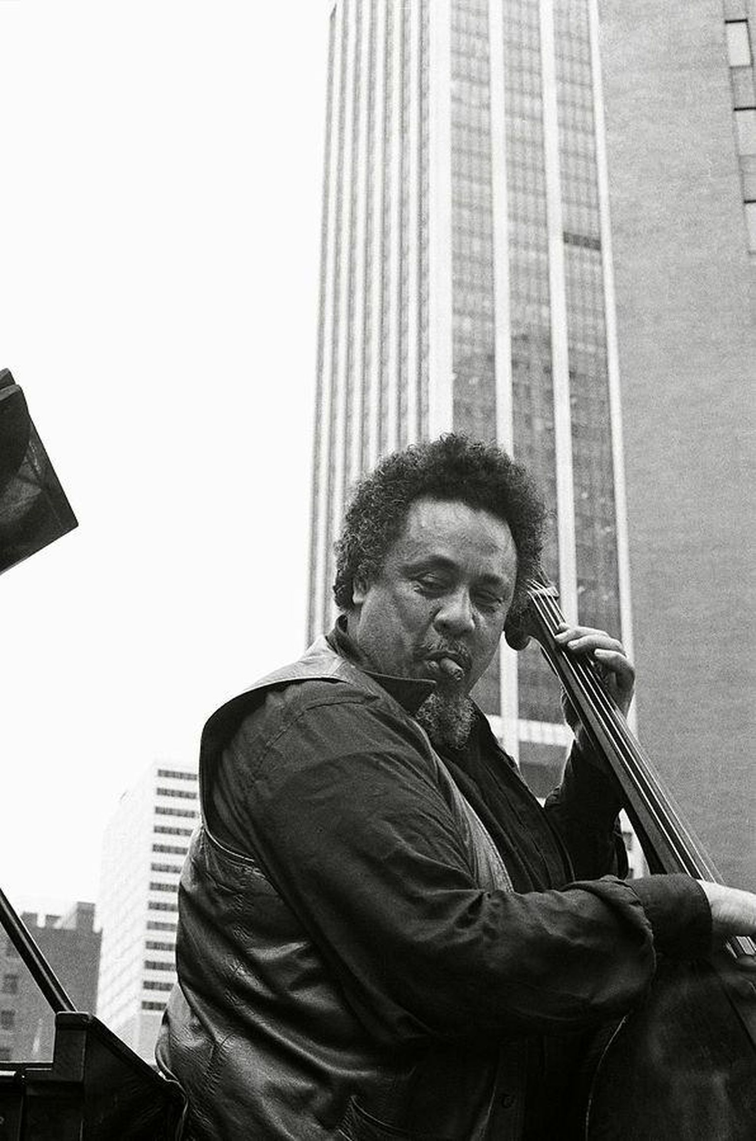 Charles Mingus, with bass, cigar and skyscraper