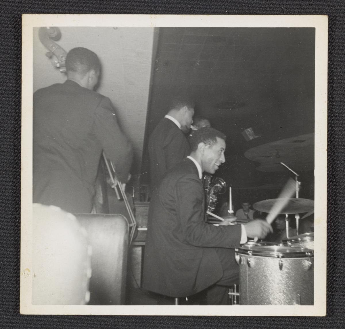 Max Roach on drums, smiling, with George Morrow, Sonny Rollins and (barely visible) Kenny Dorham, around 1958. From Gertrude Abercrombie’s papers